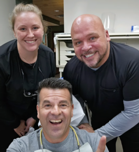 Dr. Aric Kuehner with dental patient at work